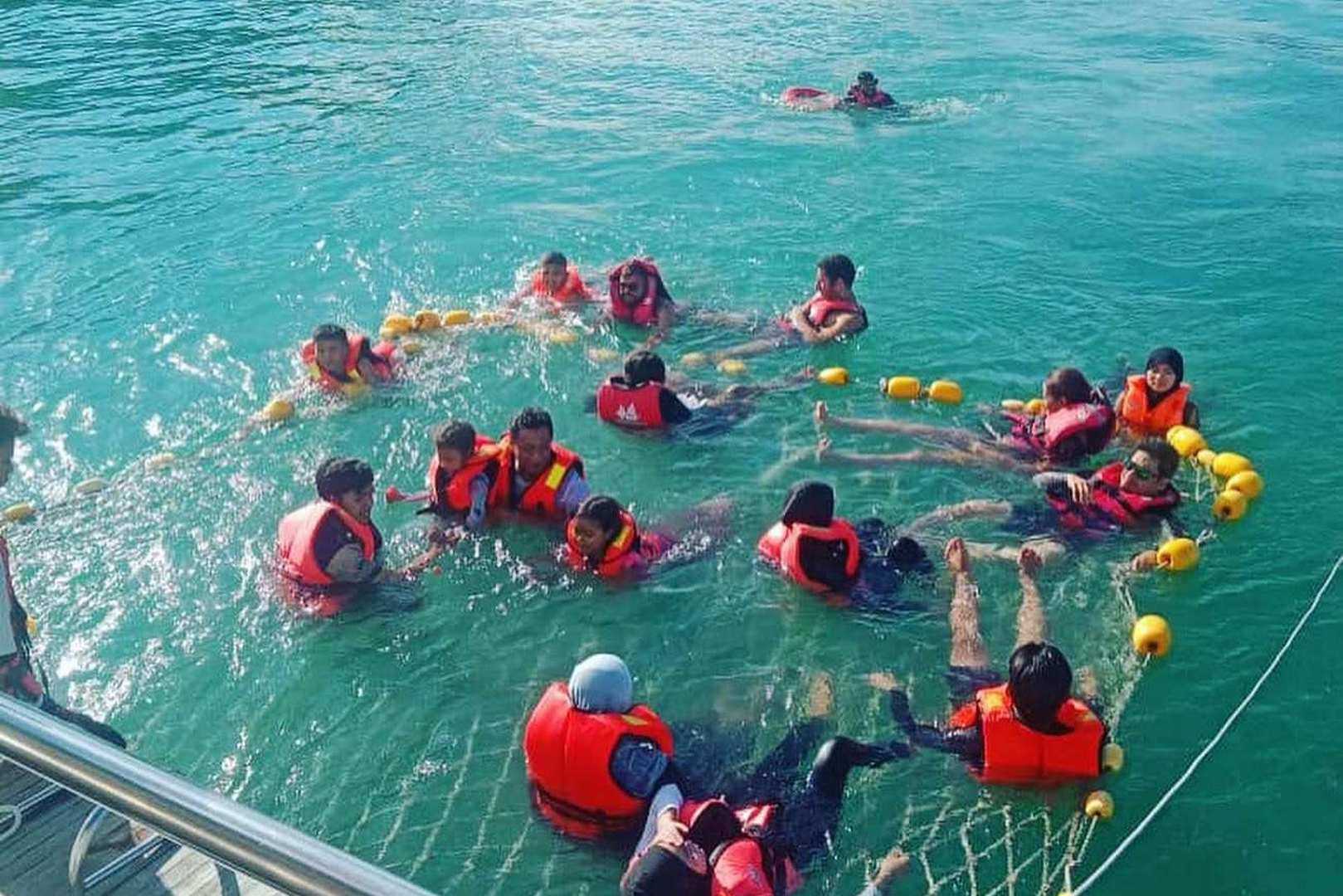 Guests in crystal-clear waters while on Langkawi halal sunset cruise